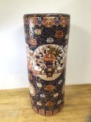 A Chinese cylindrical stick stand with floral and gilt decoration and wooden base, measures 63cm x