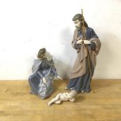 A Holy Family group of Nao figures including Mary, Joseph and baby Jesus, measures 28cm high