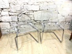 A pair of Ikea Tobias clear acrylic chairs, each measuring 83cm x 47cm x 51cm