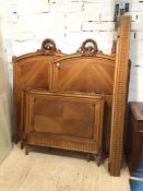 A pair of early 20thc walnut continental single bed frames, the headboards with ribbon swags,