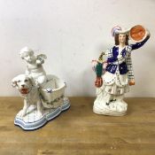 A Staffordshire flatback figure and a continental figure of a cherub riding a dog with baskets to