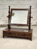 An early 19thc mahogany toilet swing mirror, the square mirror swivelling between turned uprights