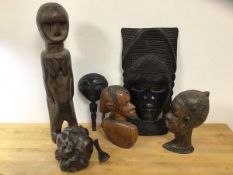 A collection of carved African art including fertility figure, measures 50cm high, wall face mask, a