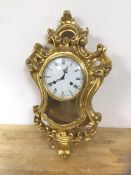 A 1970's Sainte-Helene German Rococo style wall clock, within a gilt composition frame, measures