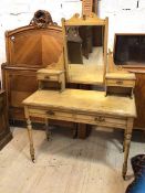 An Edwardian dressing table the hinged bevelled mirror with moulded crest rail, flanked by two