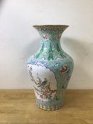 A Chinese baluster shaped vase with flared rim and enamel decoration and flowers a/f, measures