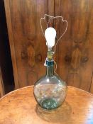 A glass bottle table lamp base of bulbous form, a/f, measures 40cm to top of lampholder