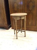 An Arts & Crafts style oak occasional table the circular top with moulded edge over four pierced