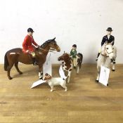 A group of Beswick china figures including three hunting figures on horse back, tallest measures