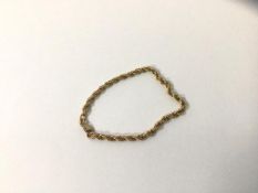A bracelet marked .375, measures 9cm and weighs 5.24 grammes