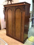 A Victorian mahogany double wardrobe the projecting cornice over leaf carved carboles flanking