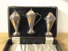 A 1934 Birmingham silver condiment set including salt, pepper and condiment pot, all weighted, a/f