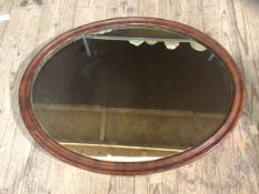 An Edwardian oval wall mirror with moulded frame, measures 49cm x 64cm