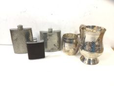 A group of three flasks, one textured pewter, measures 12cm high, another engraved with thistles and