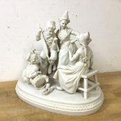A bisque china figural group of Dutch children in conversation, measures 20cm high