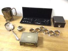 A mixed lot of Epns including a set of six napkin rings, cigarette box, mug, spoon and pill box,