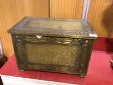 An early 20thc aesthetic style beaten brass coal box, measures 33cm x 51cm x 31cm