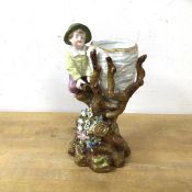 A Dresden boy on tree and nest bud vase, measures 20cm high