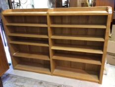 A Yorkshire oak style twin section open bookcase, the adzed top and sides enclosing eight adjustable