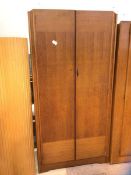 A mid century Avalon yatton two door wardrobe, interior with shelf and hanging space, on plinth