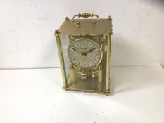 A President brass mantel clock lacking one foot, measures 20cm high