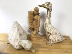 A carved African figure with drum, measures 35cm high, and two ceramic painted ducks (3)