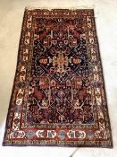 An Iranian Nahavand hand knotted rug, of all over floral geometric design with guarded border, 277cm