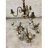 A set of four Dutch style brass chandeliers, with scrolled arms, faux candles, chain and ceiling