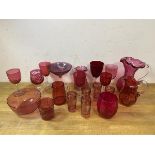 A collection of Edwardian cranberry glass including water jugs, tallest measures 18cm high, sherry