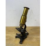 An early 20thc microscope, inscribed to base, measures 19cm high