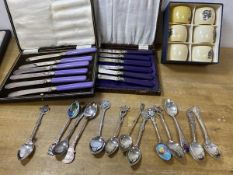 A mixed lot including a collection of souvenir spoons, some marked silver, two box sets of six