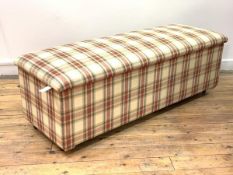 A 20th century Ottoman, the hinged seat and sides upholstered in chequed cotton, raised on