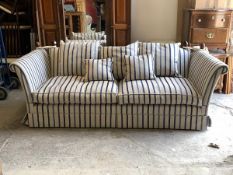 A contemporary Knoll style drop arm sofa, upholstered in striped natural linen fabric, with squab