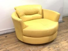 An oversized Contemporary circular swivel lounge chair, upholstered in custard yellow leather,