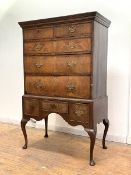 An 18th century and later walnut chest on stand, the projecting cornice over two short and three