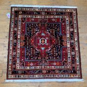 A hand knotted North West Persian rug, of all over geometric design and with multiple guard stripes,