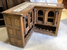 An Early 20th century oak corner bar of architectural form, the top later inset with tiles, over two