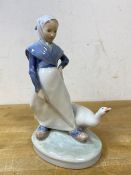 A Royal Copenhagen figure of girl tending goose, measures 19cm high