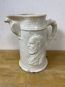 A late 19thc glazed stoneware pitcher depicting President Garfield to either side, spout supported