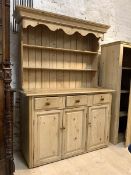 A Victorian style pine dresser, the projecting cornice over two height plate rack, with three