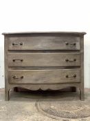 A French style grey painted bow front commode, fitted with three long drawers over a shaped apron,