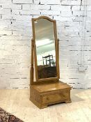 A Victorian style satinwood cheval mirror, the arched mirror swivelling between two turned uprights,