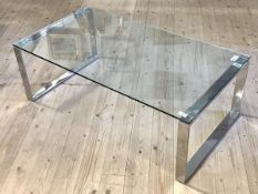 A contemporary coffee table the glass top on open square polished metal supports, measures 38cm x