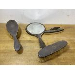 A 1920's Birmingham silver toiletry set including hand mirror, hair brush, clothes brush and nail