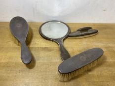A 1920's Birmingham silver toiletry set including hand mirror, hair brush, clothes brush and nail