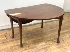 A George III mahogany swing leg drop leaf dining table, the oval top raised on turned supports