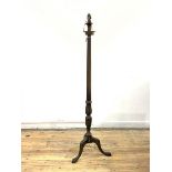 A Georgian style mahogany standard light, the leaf carved, turned and fluted column raised on triple