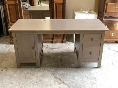 A Contemporary stained pine twin pedestal desk, the rectangular top over a cupboard and two drawers,