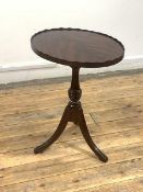 A reproduction Georgian style wine table, the oval tray top over turned column and triple splay