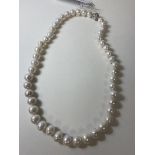 A strand of cultured pearls with cz set magnetic clasp fastening, measures 23cm